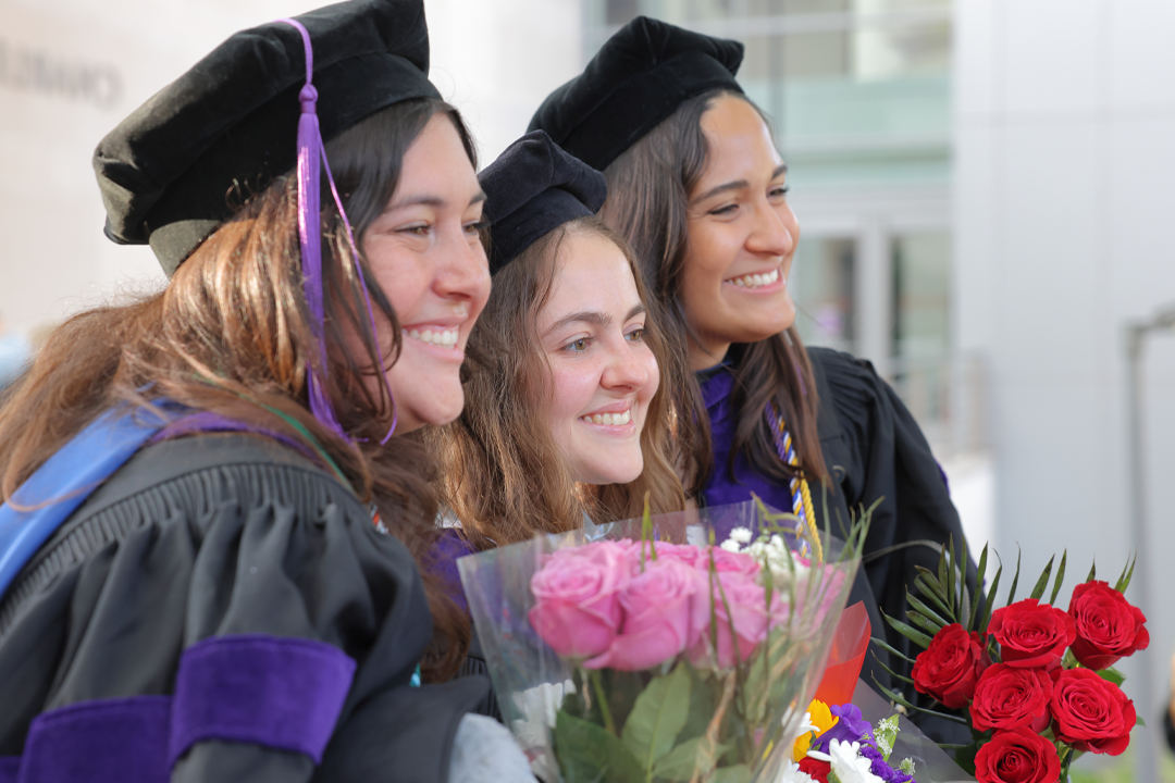 Three graduates posting for a photo after the diploma ceremony.